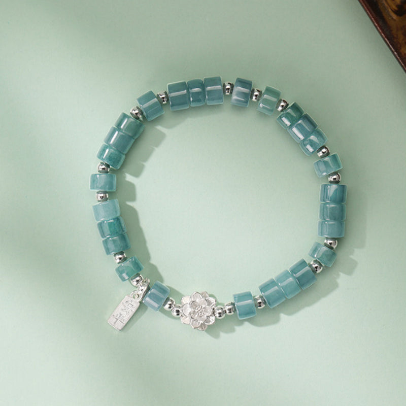 Bracelet de lotus en jadéite orientale avec breloque « Ping An Xi Le » – Bijoux Guochao